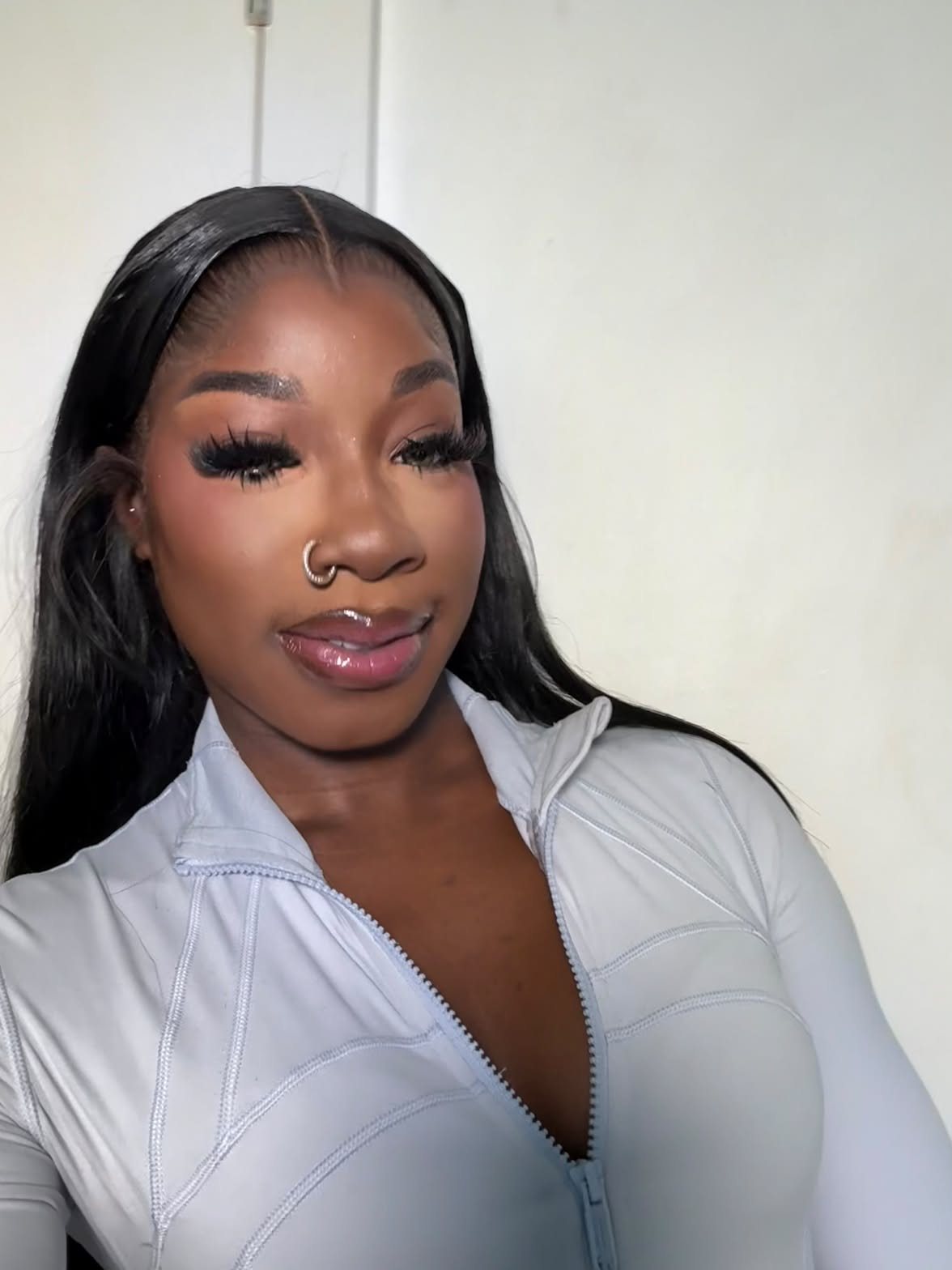 Guynelle, founder of Atelier Adorn, in a white zip-up top